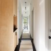 Main hallway, Cali Bamboo flooring, Plumen 003 Dimmable LED Pendant Set, runner made from offcuts by Oliver Yaphe, Emtek door hardware, Airlite zero VOC paint and ply/Richlite cabinetry by Mike Gagne.